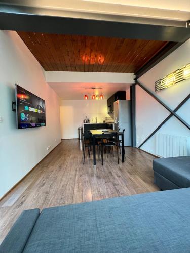 a room with a dining table and a kitchen at Pere Lachaise Apartments in Paris