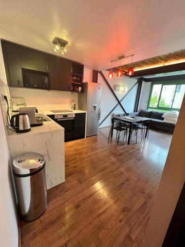 a kitchen and living room with a table and chairs at Pere Lachaise Apartments in Paris