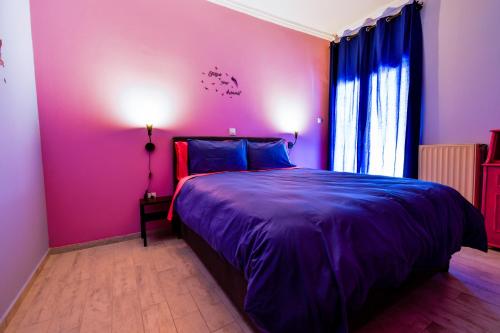 a bedroom with a purple bed and a window at Tonias house in Athens 2 in Athens