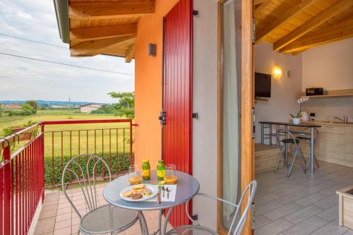 a patio with a table and chairs on a balcony at Villa Camporosso in Colà di Lazise