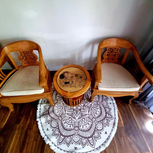 a group of three chairs sitting on a floor at Marquise & Infinity villas in Glacis