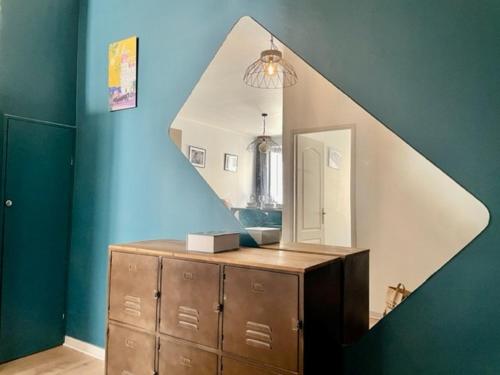 a bathroom with a mirror and a dresser with a staircase at Un havre de paix et de calme en plein centre de Massena in Nice