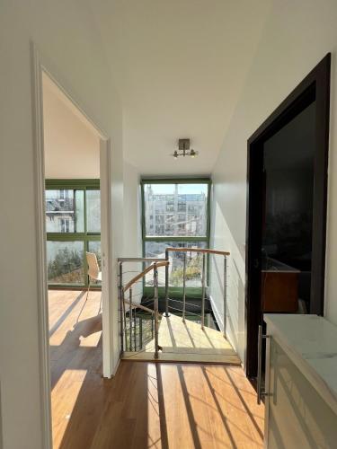 a room with a staircase leading to a balcony at Pere Lachaise Apartments in Paris