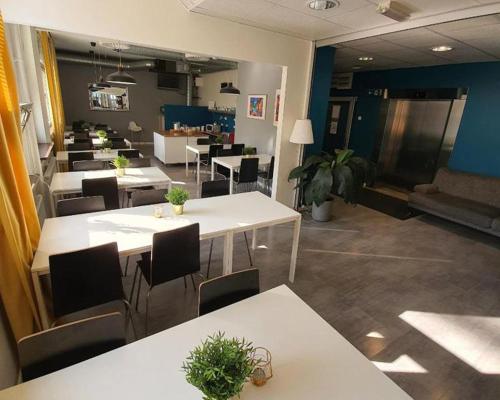 a dining room with tables and chairs in a room at Metro Apart Hotel in Stockholm