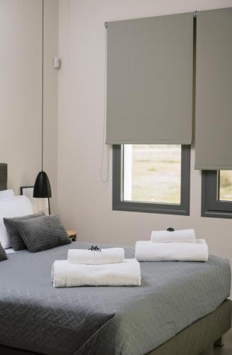 a bedroom with two beds with towels on them at Grand Sea View Luxury Villa in Kalamaki Heraklion