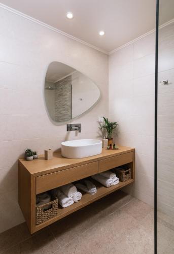 a bathroom with a sink and a mirror at Grand Sea View Luxury Villa in Kalamaki Heraklion