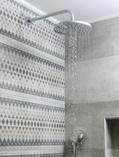 a shower with a shower head in a bathroom at Grand Sea View Luxury Villa in Kalamaki Heraklion
