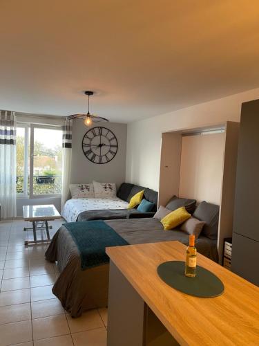 a bedroom with a bed and a clock on the wall at Studio Disneyland Paris Holidays in Montévrain