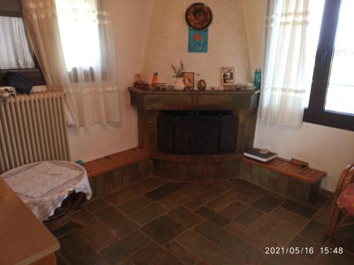 a living room with a fireplace in a room at Sea view Dilesi in Dhílesi