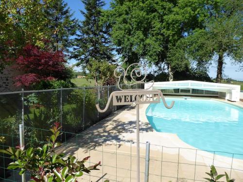 a sign that reads welcome to a swimming pool at Private Gite with heated pool with retractable cover and hot tub in Cendrieux