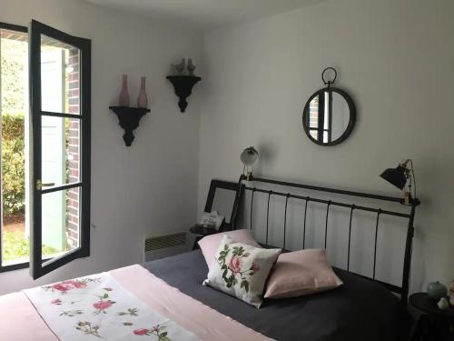 a bedroom with a bed and a mirror on the wall at Beautiful ground floor 2 bedroom apartment in Honfleur