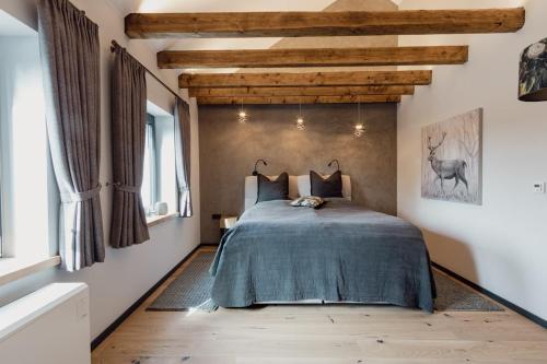 een slaapkamer met een bed in een kamer met houten plafonds bij Asten-Chalets in Winterberg