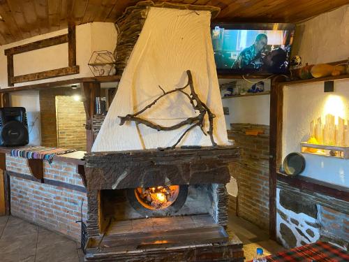 a brick oven with a covering on top of it at Александрова вила 1 in Zlatograd