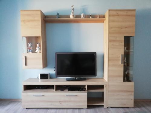 a wooden entertainment center with a television on it at Wohnung in Pöttsching