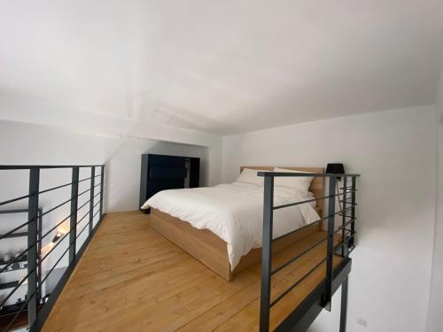 a white bedroom with a bed and a balcony at Soppalco in Martina Franca