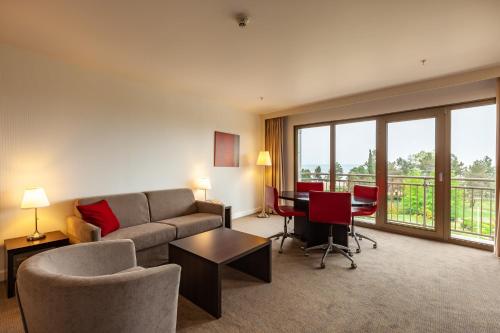 a living room with a couch and a table at Novotel Trabzon in Trabzon