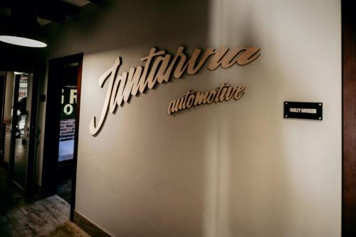 a sign on the side of a building at Jantarvia Car Museum , Pasja i Wypoczynek Noclegi z Klimatem in Jantar