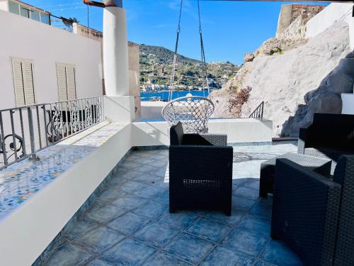 a balcony with chairs and a view of the water at "Sweet Life" Casa Vacanze in Lipari