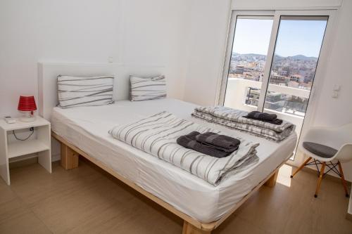 Ένα ή περισσότερα κρεβάτια σε δωμάτιο στο Komfort City Apartment "Elias" mit Meerblick in Lavrio