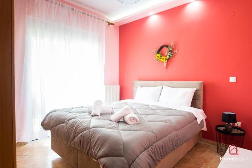 a red bedroom with a bed with two dolls on it at Eva's House Project by Homebrain in Alexandroupoli