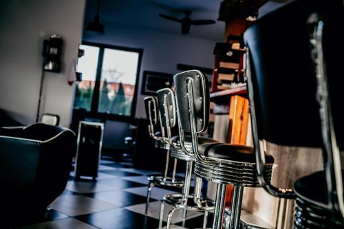a row of bar stools in a barber shop at Jantarvia Car Museum , Pasja i Wypoczynek Noclegi z Klimatem in Jantar