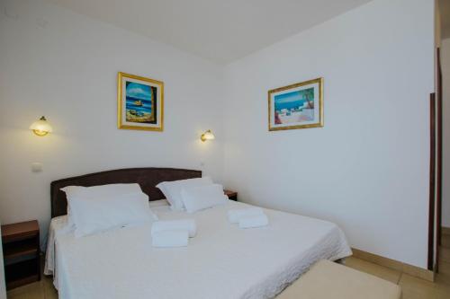 Postel nebo postele na pokoji v ubytování Hotel Vila Tina