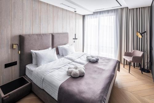a bedroom with a bed with two stuffed animals on it at Loft7 in Lviv