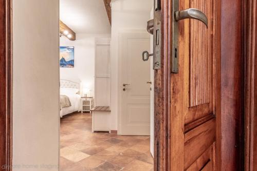 a door leading to a bedroom with a bed at Casa Maghinardo in Brisighella