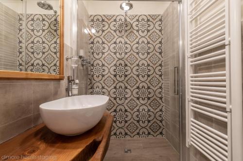 a bathroom with a white bowl sink and a shower at Casa Maghinardo in Brisighella