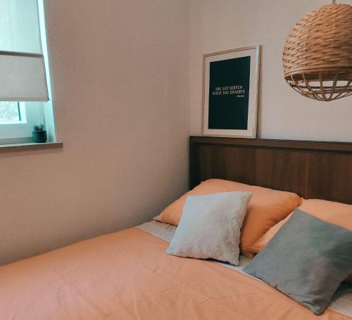a bed with two pillows on it in a bedroom at Nika in Postira