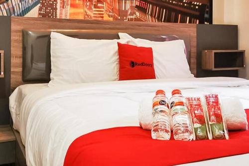 a group of water bottles sitting on a bed at RedDoorz Plus @ Taman Madiun in Madiun