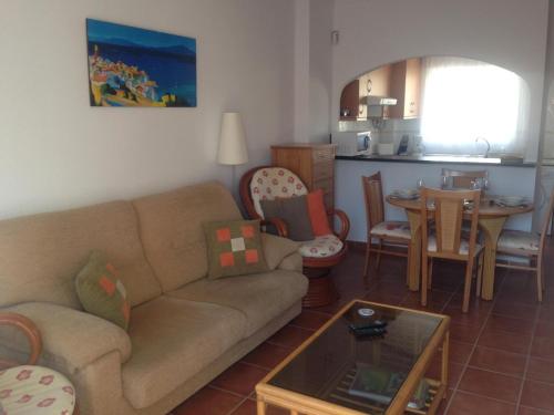 a living room with a couch and a table at AZ02 Roof top terrace apartment, 2 bedrooms, 1 bathroom, very close to beach in La Azohía