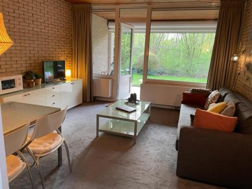 a living room with a couch and a table at Appartement Zeeland, Bark 46 in Bruinisse