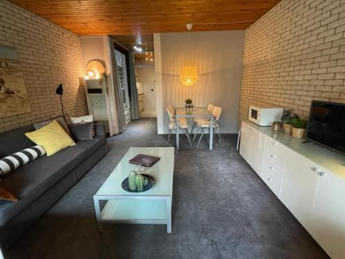 a living room with a couch and a table at Appartement Zeeland, Bark 46 in Bruinisse