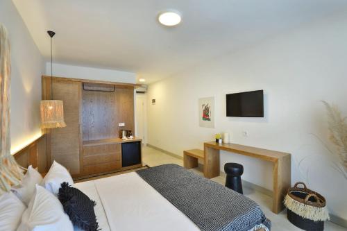 a bedroom with a large bed and a television at Lavinya Otel in Golturkbuku