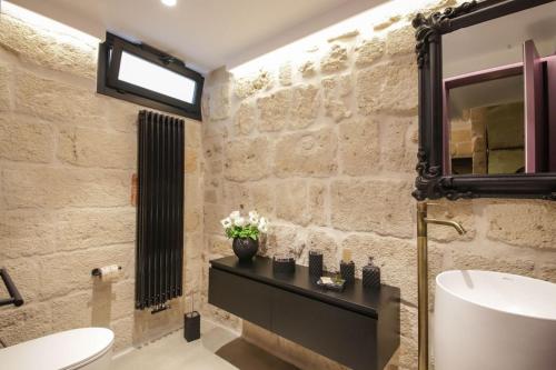 a bathroom with a sink and a mirror at SUITE & SPA VIA VENETO in Monopoli