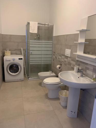 een badkamer met een wastafel en een wasmachine bij CASA 8 GIUGNO in Melegnano