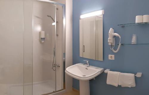 een badkamer met wastafel en douche bij Hotel Novo Muiño in A Guarda