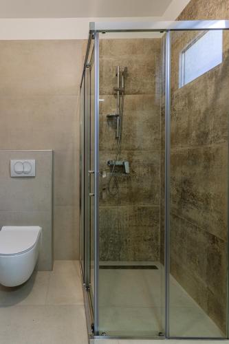 a glass shower in a bathroom with a toilet at Sea Paradise in Cres