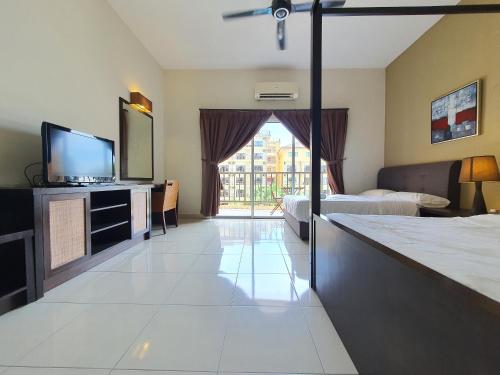 a large hotel room with a television and a bed at Gold Coast Morib Themepark View Studio in Banting