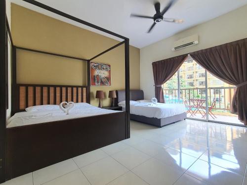 a bedroom with two beds and a large mirror at Gold Coast Morib Themepark View Studio in Banting