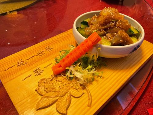 a plate with a carrot and a bowl of food at Crowne Plaza Yantai Sea View by IHG in Yantai