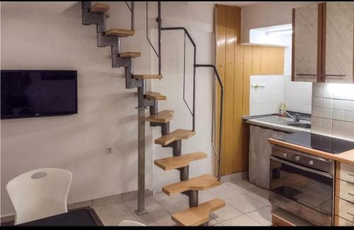 a kitchen with a spiral staircase in a kitchen at Apartment Sidro in Cres