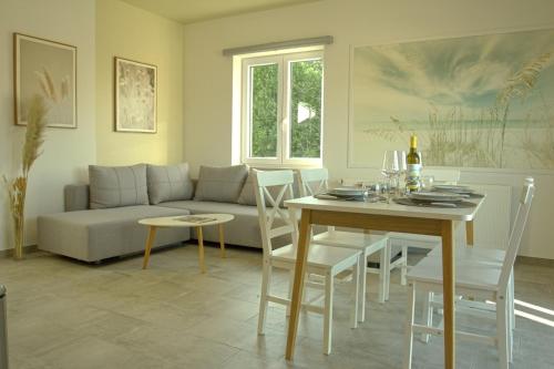 a living room with a couch and a table at Harbor apartments 2 in Opatija