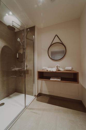 a bathroom with a shower and a mirror at Burghotel Schlaining in Stadtschlaining