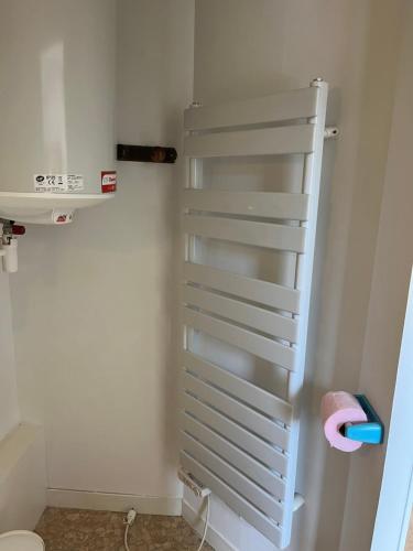 a white towel rack in a bathroom with a toilet at Petite maison au coeur du village in Mesquer