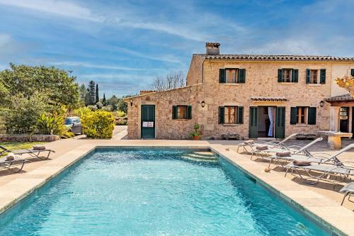 a house with a swimming pool in front of a house at Villa Prital by Sealand Villas in Pollença