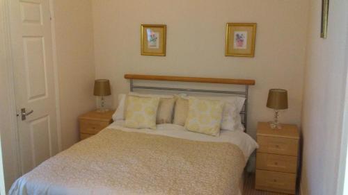 A bed or beds in a room at MYRTLE HOUSE HOTEL TENBY