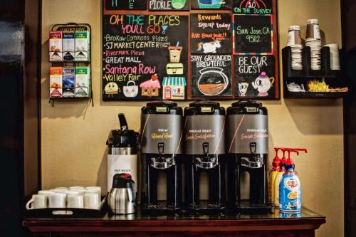 a coffee shop with a bunch of bottles on a table at Sonesta ES Suites San Jose - Airport in San Jose