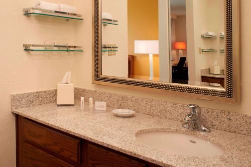 a bathroom with a sink and a mirror at Sonesta ES Suites Chicago Waukegan Gurnee in Waukegan